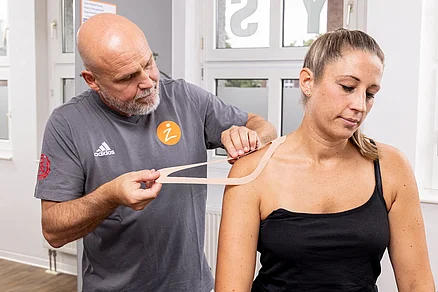 Hier wird das Kinesio - Tape an der rechten Schulter angelegt. Dies kann nach Frakturen ,nach Zerrungen, nach Immobilität und nach Operationen angelegt werden. Ziel ist die Schmerzfreiheit. Kinesiotaping
